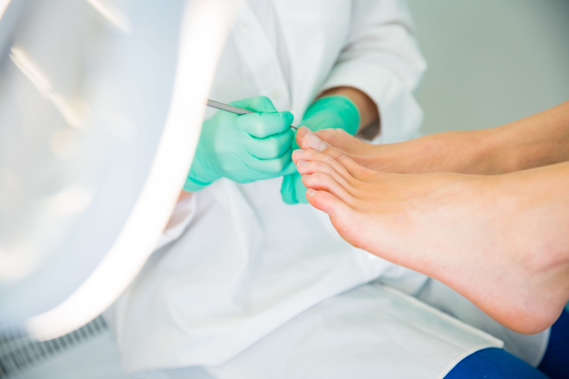 Woman sitting in chair, having foot treatment in spa salon.